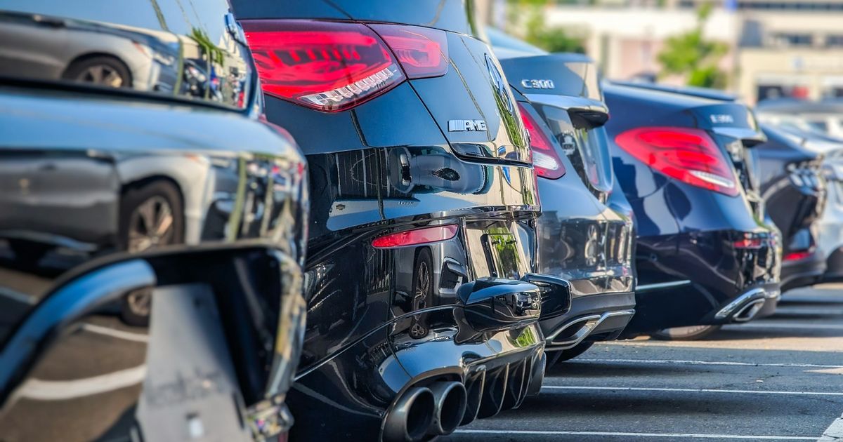Row of parked cars from a car rental company's fleet