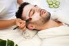 A man receiving a facial treatment.