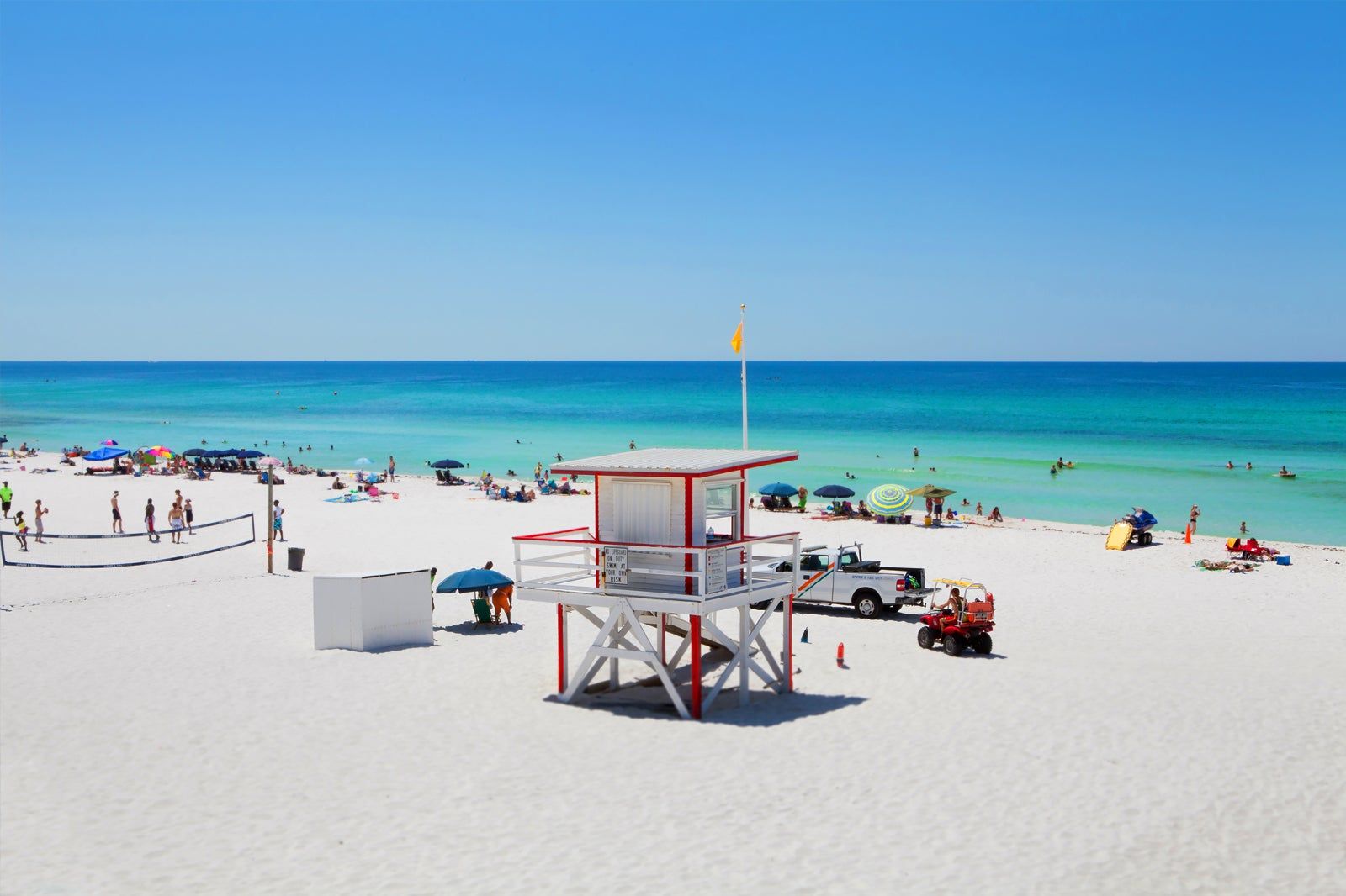 A white sandy beach with a volleyball court.