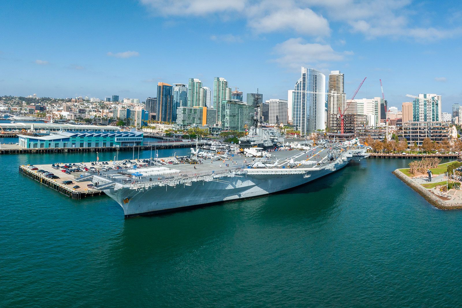 An aircraft carrier at the city port.