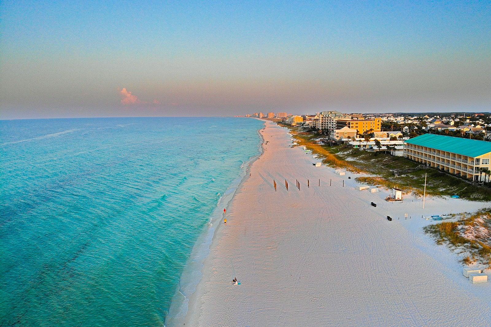 White sand beach and green water.