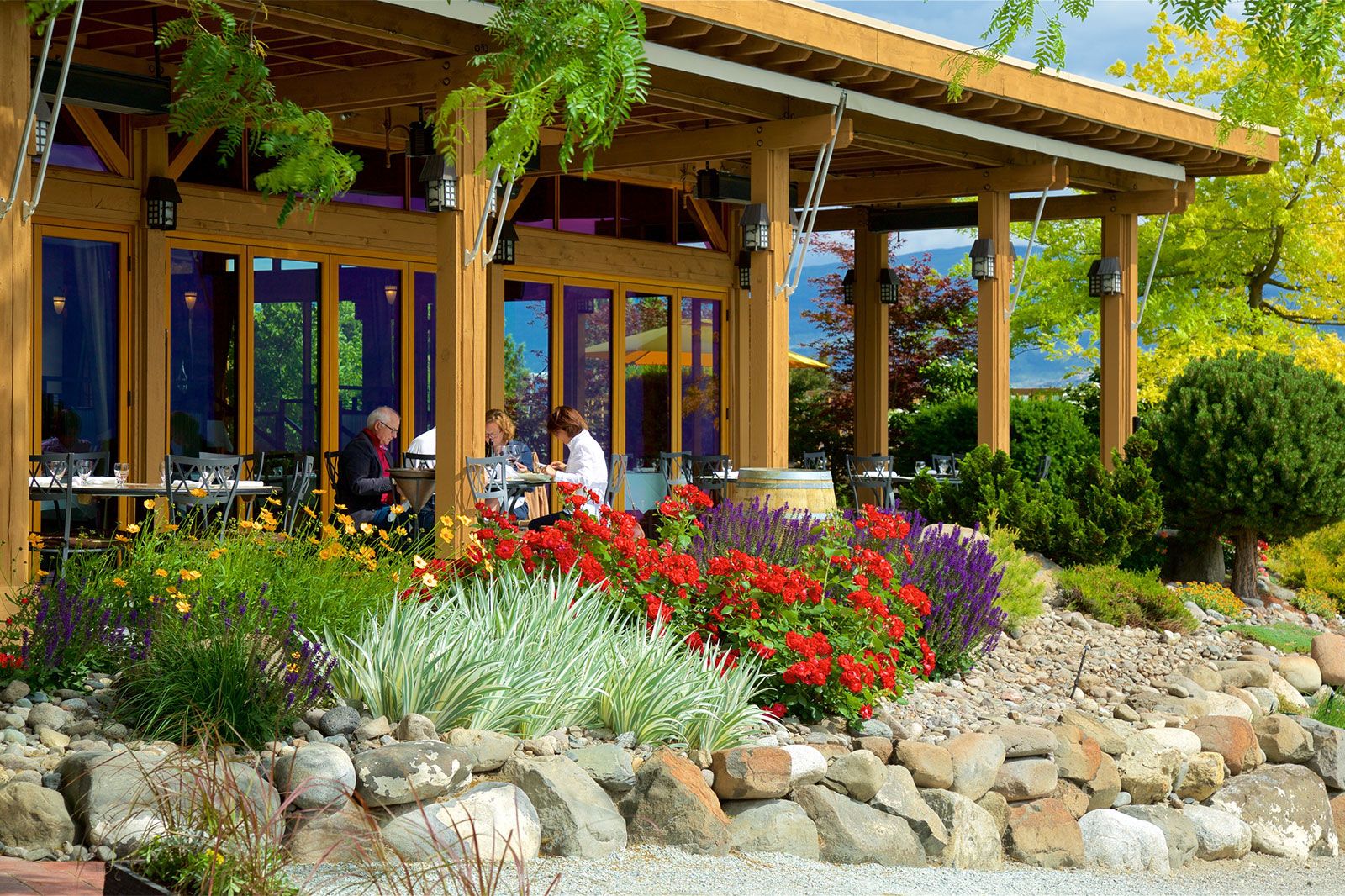 People eating at a restaurant with outdoor seating.