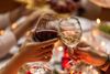 A close up of hands toasting wine glasses.