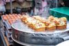 A food stall selling egg breads in a market.