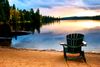A chair in front of a lake.