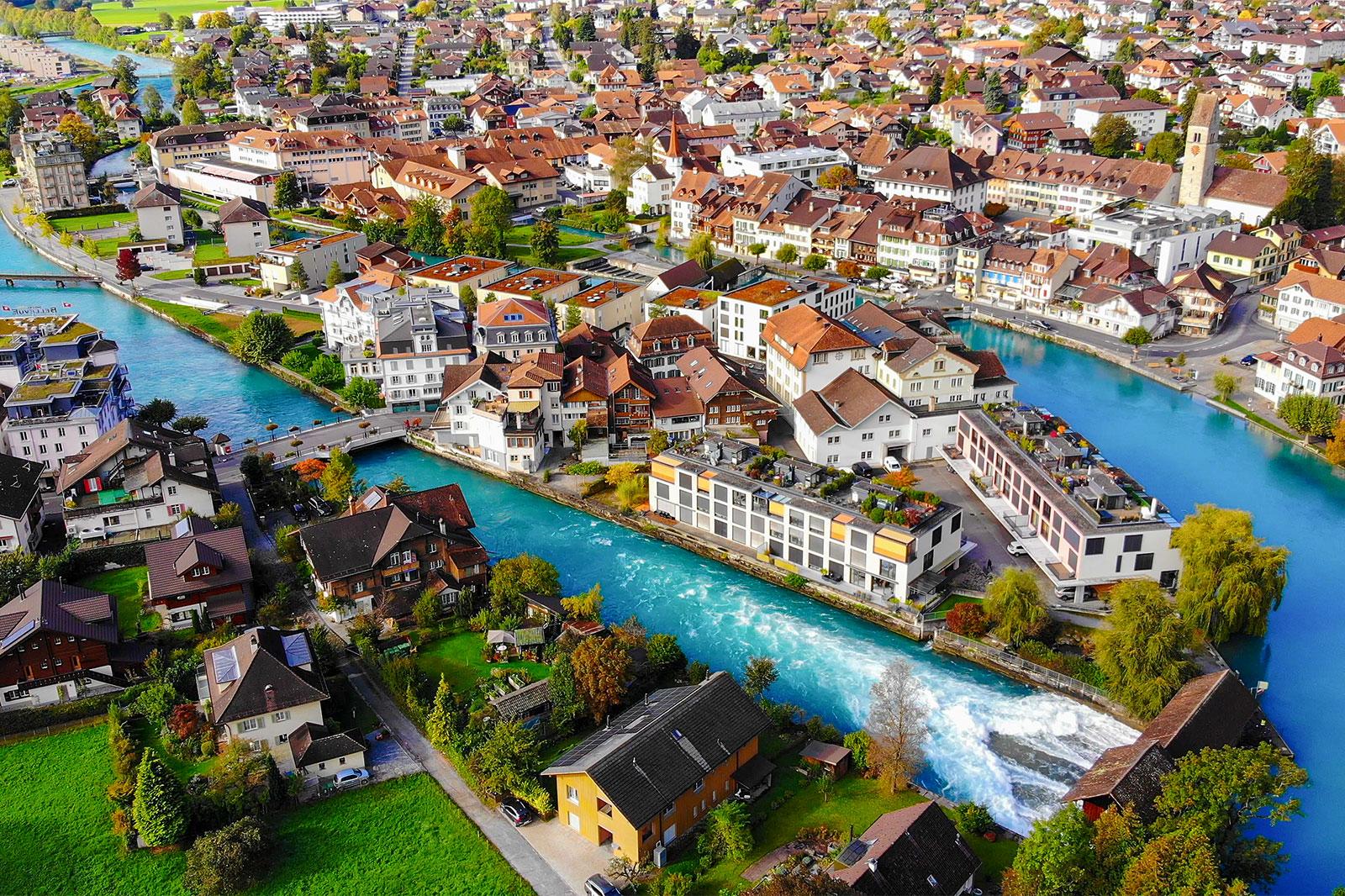 A city view of a river and damn through the town.