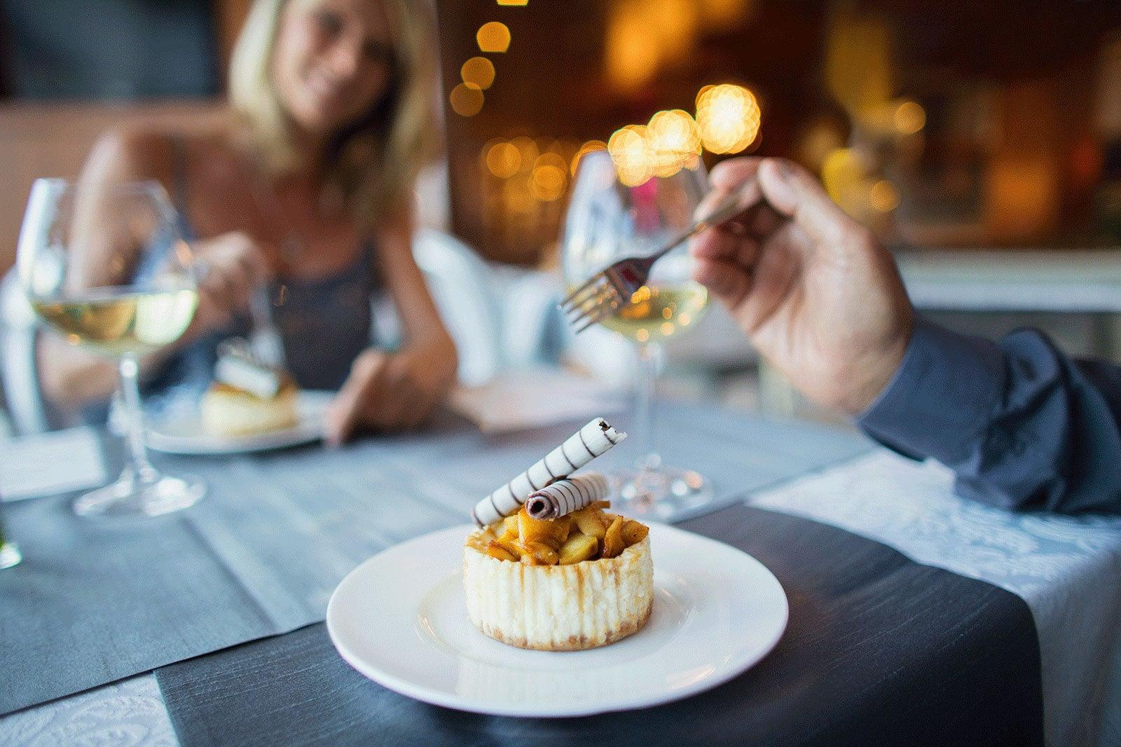 Man taking a bite of a dessert.