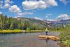 Fly fisherman in a river with mountain view.
