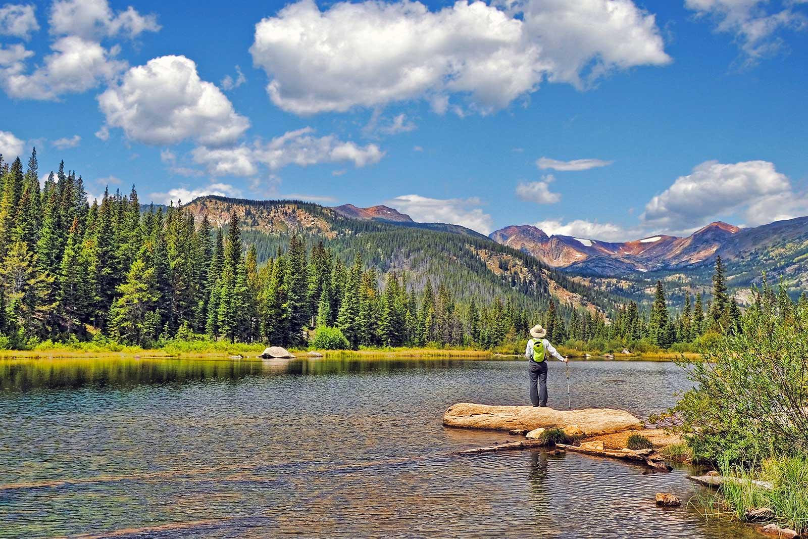 Fly fisherman in a river with mountain view.