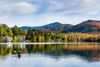A kayaker on a smooth lake.