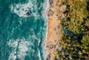 An aerial view at sunset of a rocky beach.