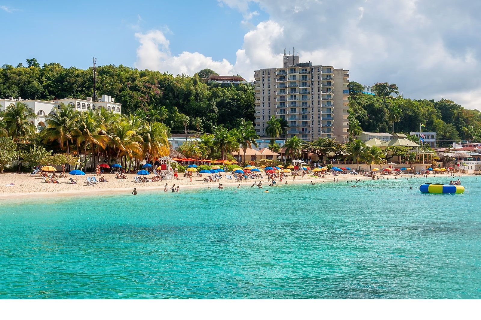 A small beach in a bay with blue water.