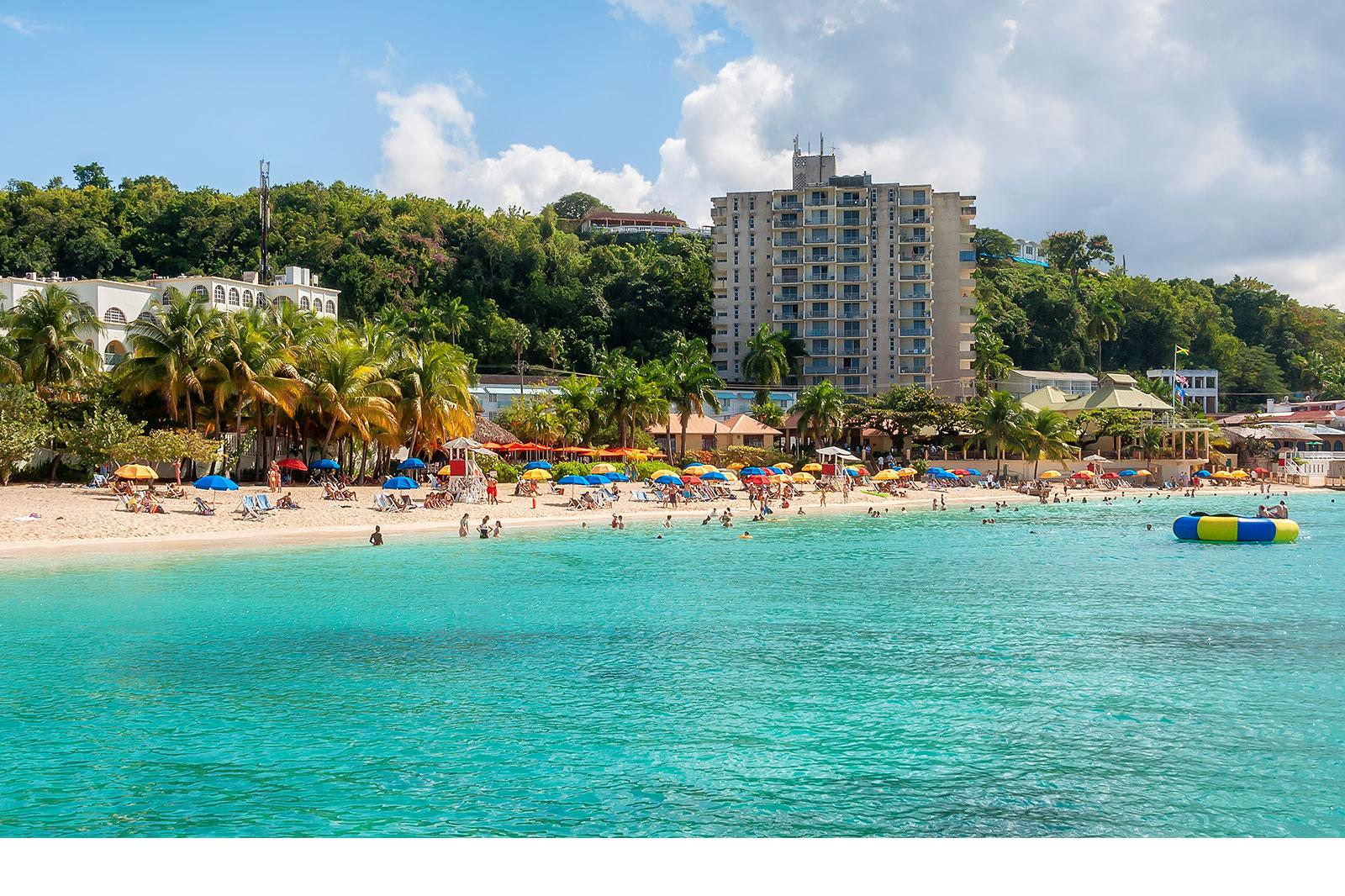A small beach in a bay with blue water.