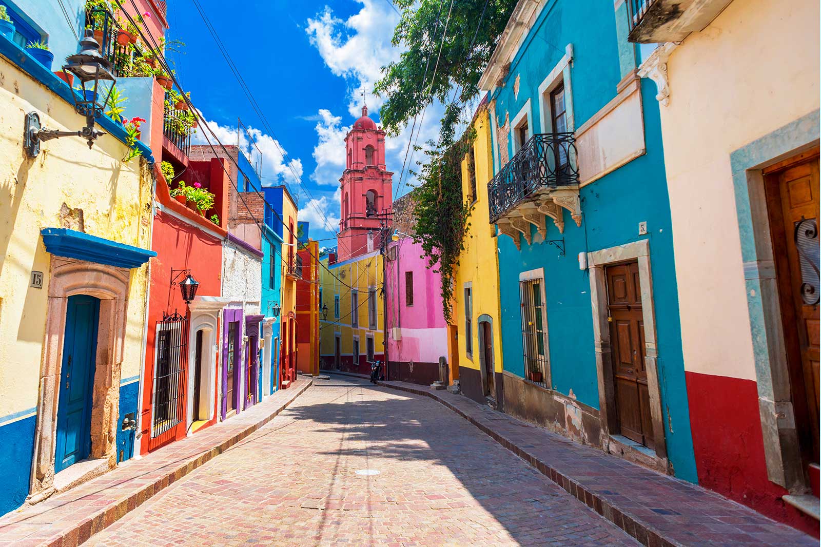 Colourful houses lining a narrow street.