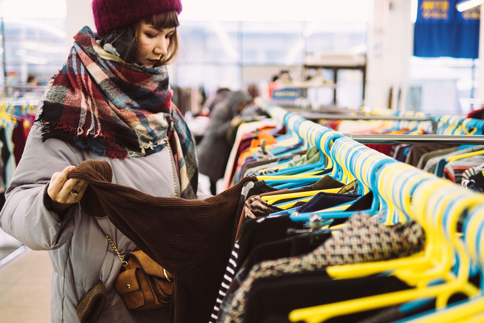 A woman looking at clothes. 