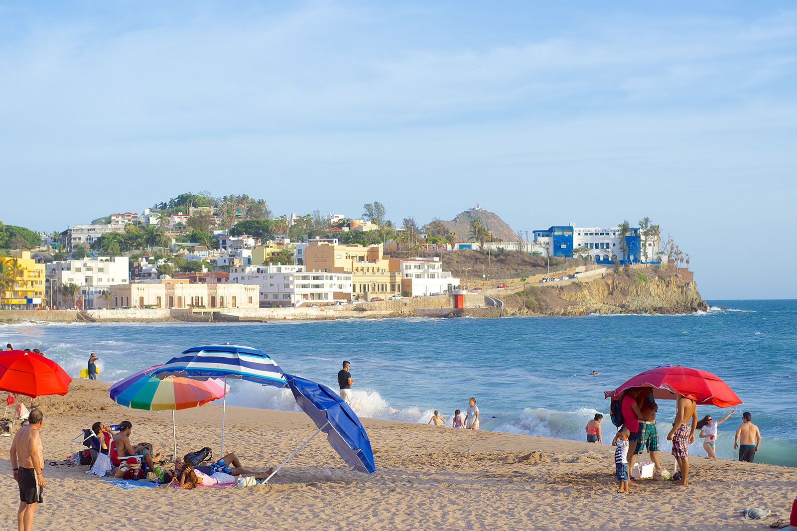 A beach with an old city in the background