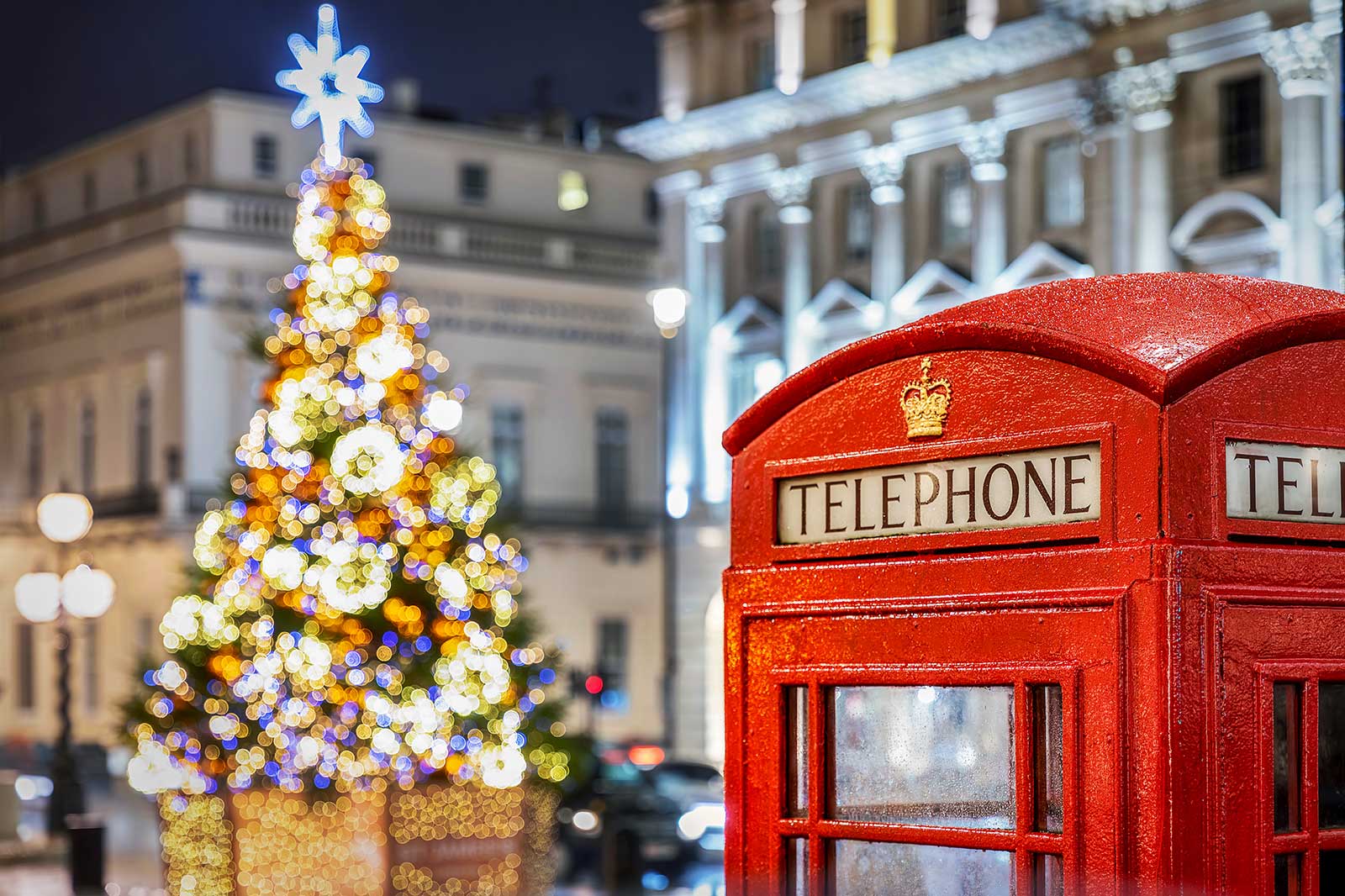 A red telephone box and a colourful Christmas tree.