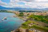 An aerial view of a beach, pier and town on the coast.