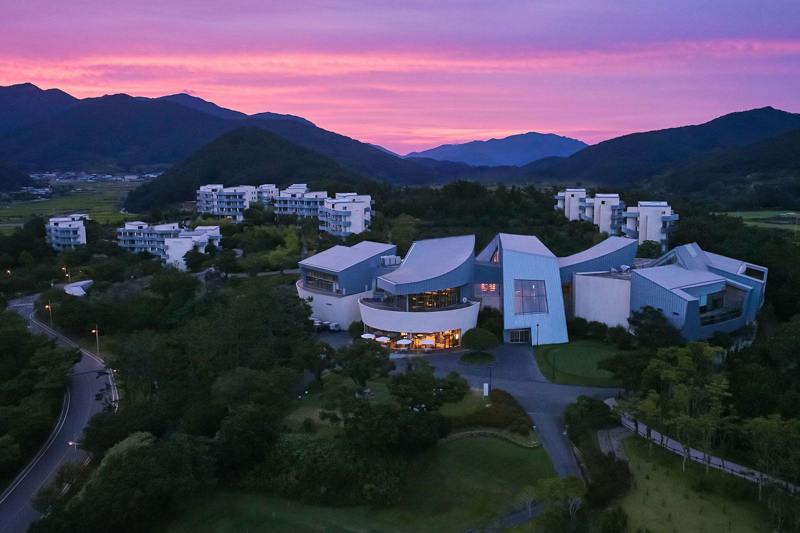 An aerial view of a building on top of a hill.