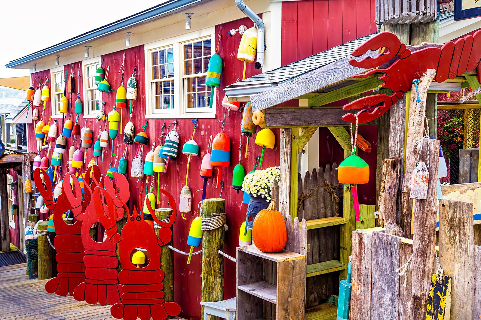 Ocean buoys hang outside a shop. 