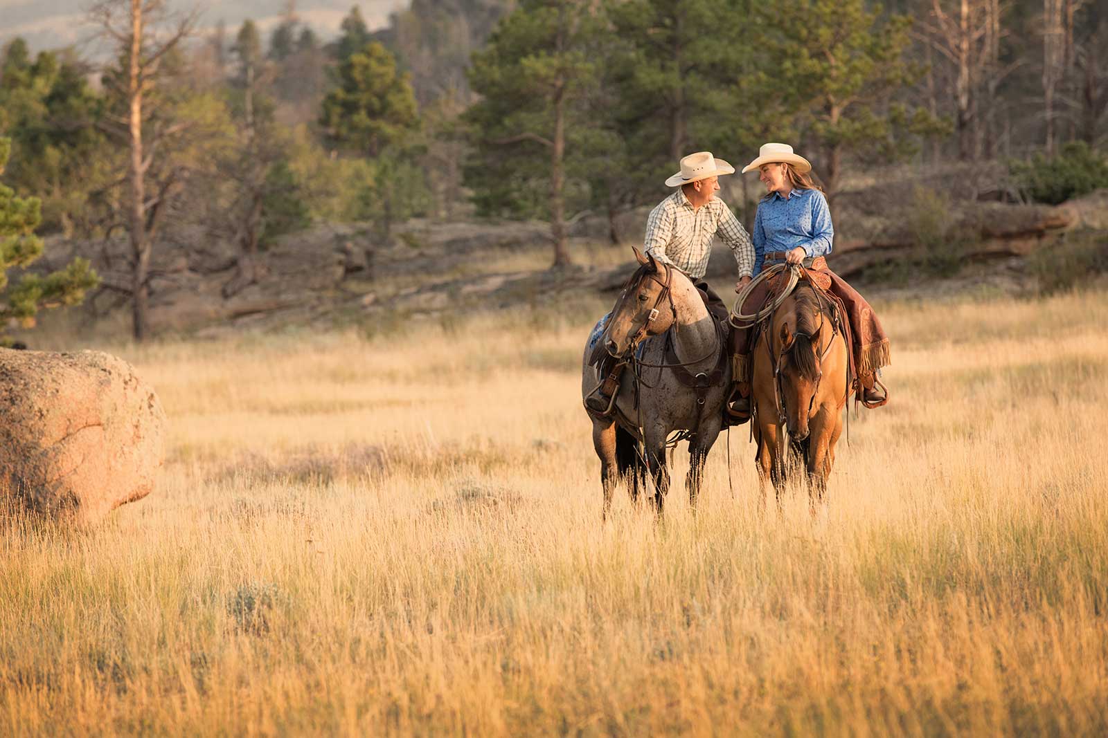 A man and woman on horseback.
