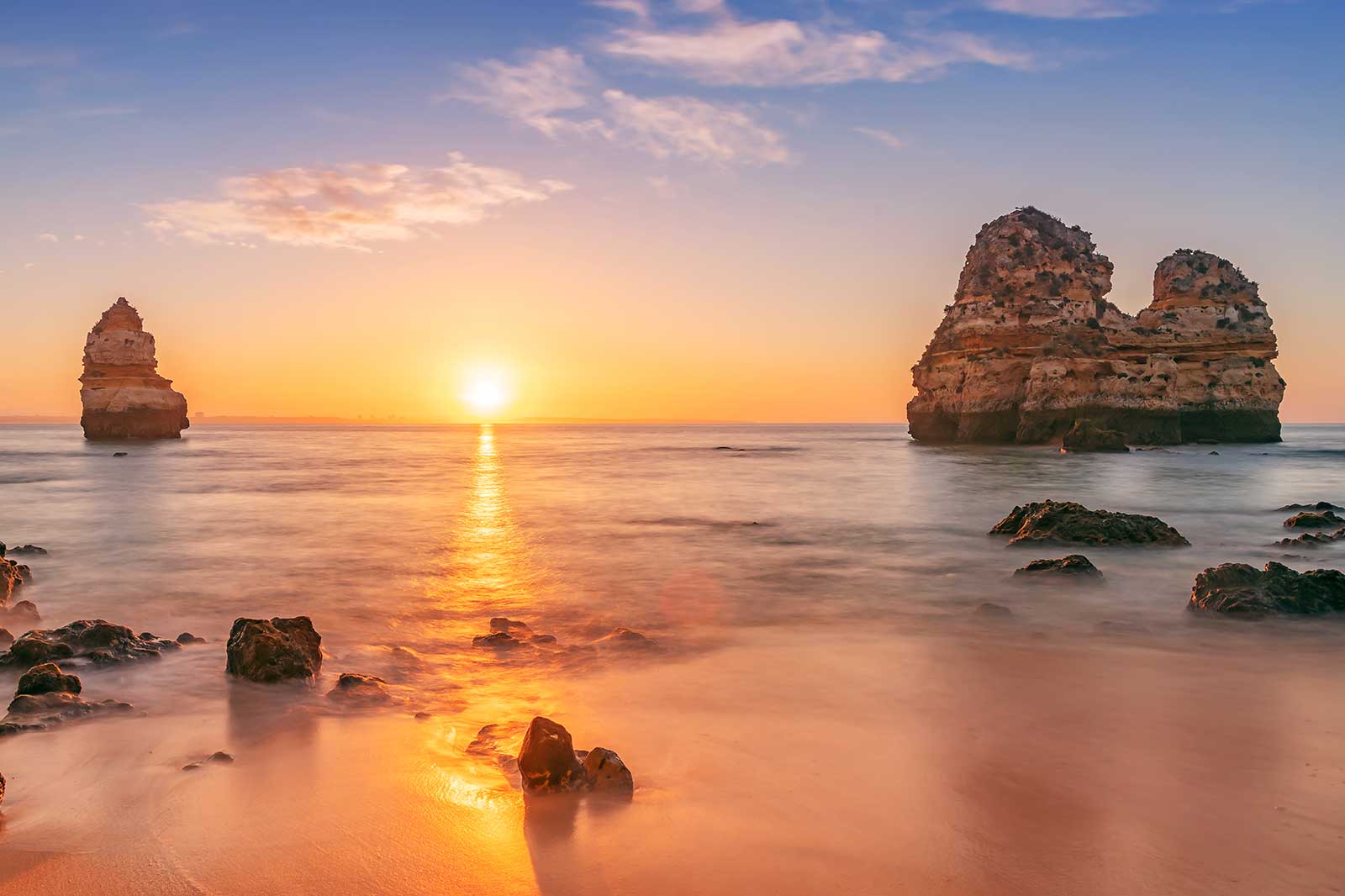 A rocky beach at sunset.