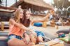 Two women at a beach club.