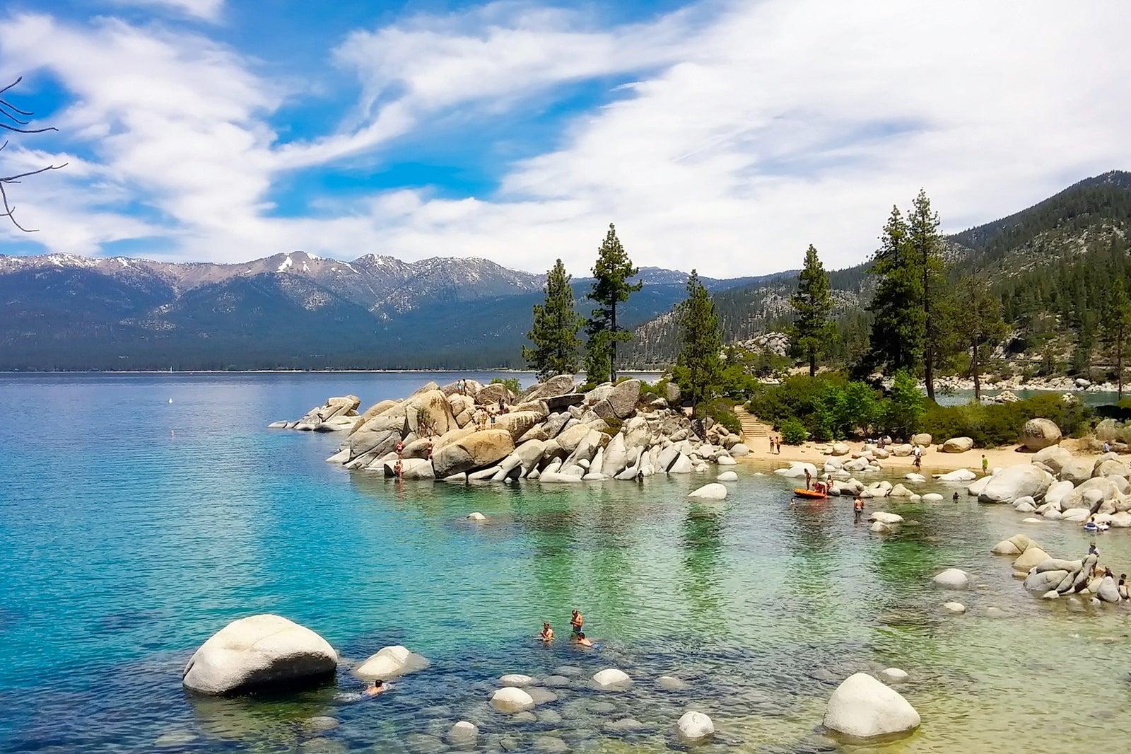 A rocky beach against a mountain view.