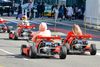 People go kart through the city streets.