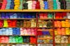 A shelf with filled with colorful yarns.