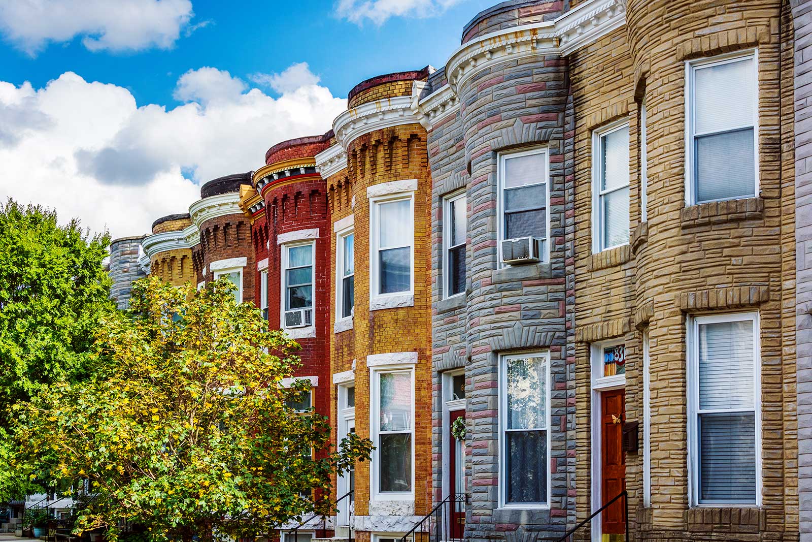 A row of colorful brownstone buildings.