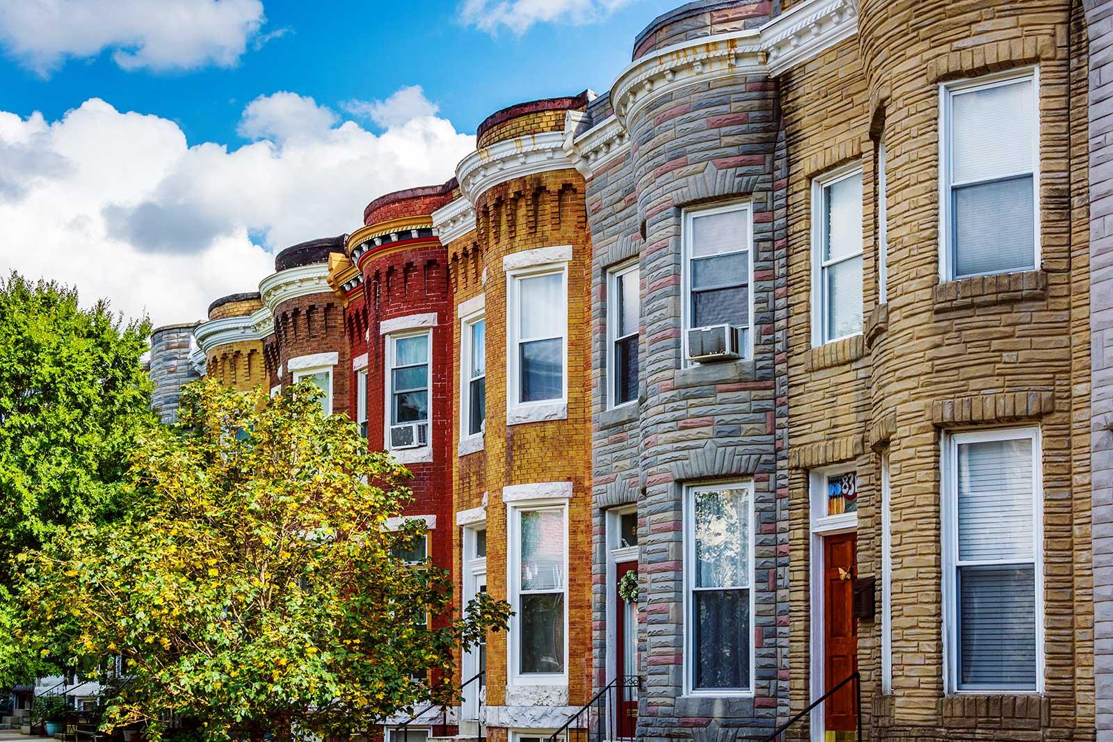 A row of colorful brownstone buildings.