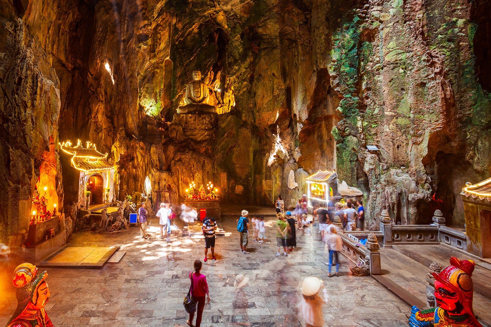 A cave with people and shrines.
