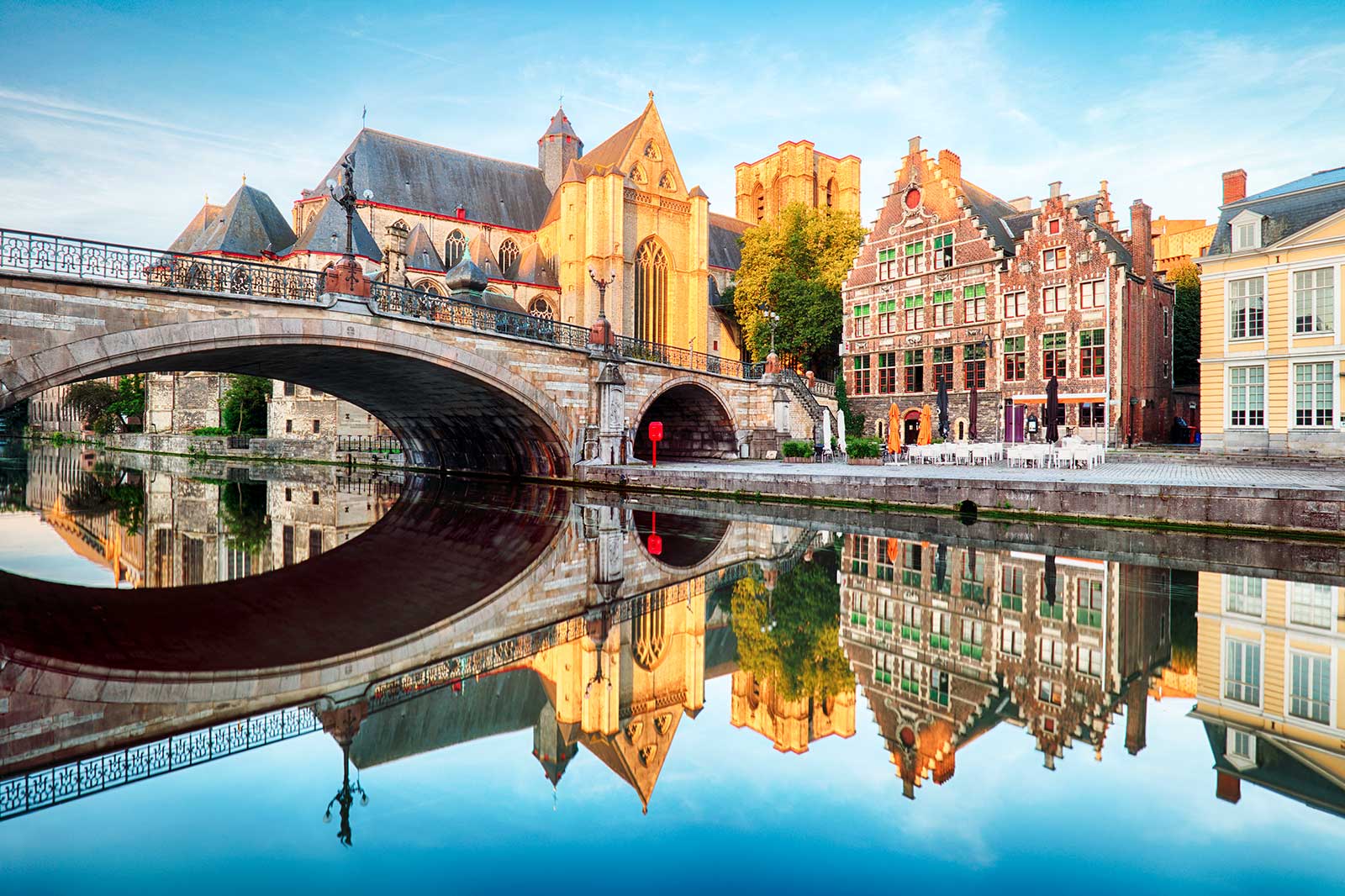 Medieval cathedral and bridge over a canal in Ghent.