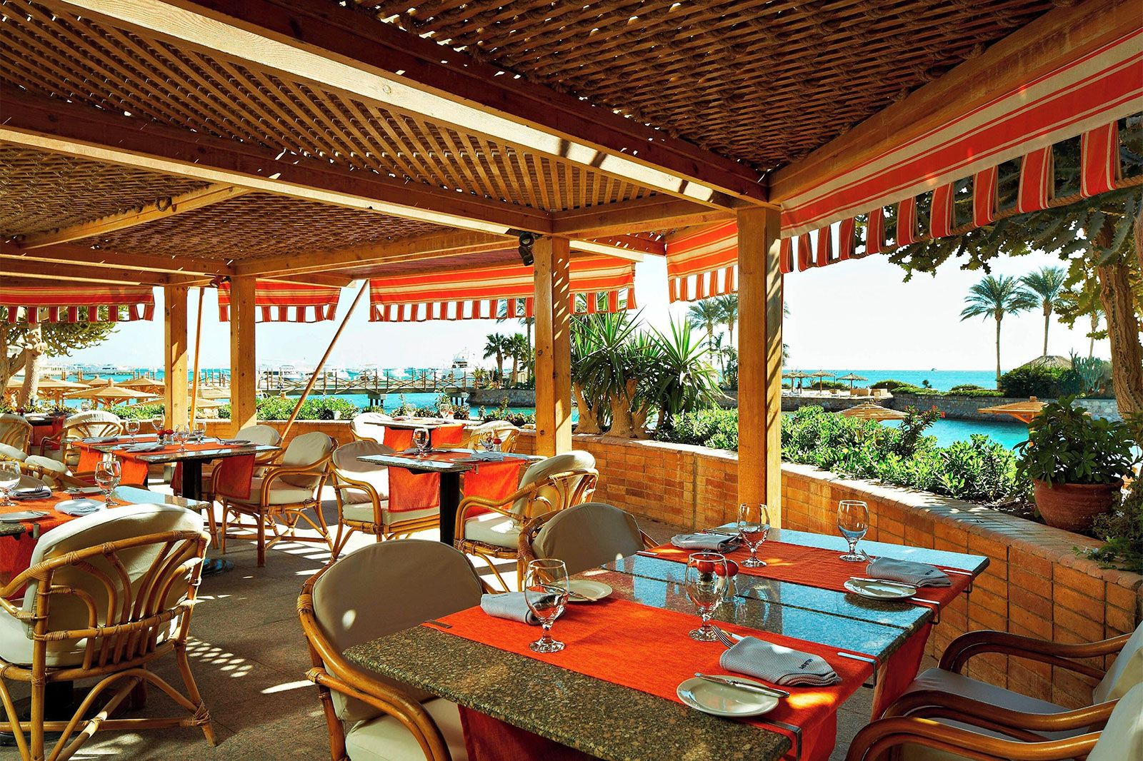 A colorful resturant looking out to the ocean.