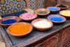 Dishes of powdered color paint for sale.