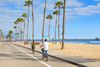 People biking by the beach.