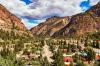 A view of Ouray mountain town buildings in Colorado nestled between mountains.