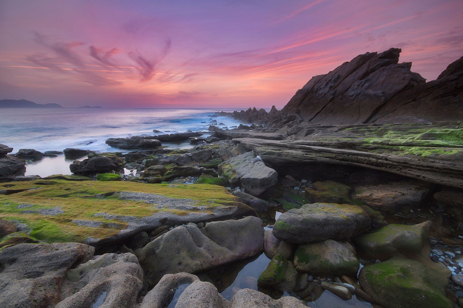 A sunset over a rocky coast.