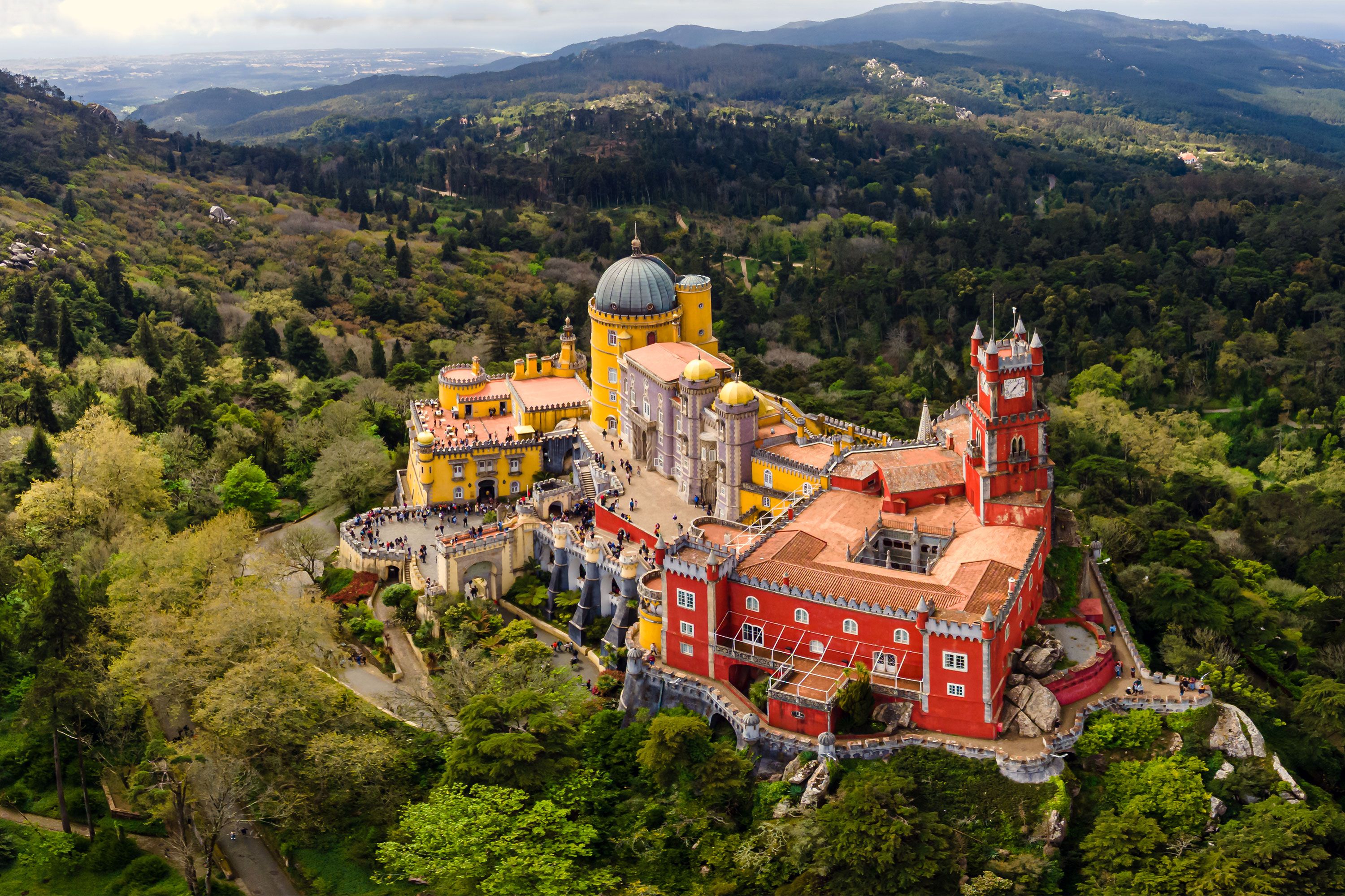 A colorful palace on a green mountain.