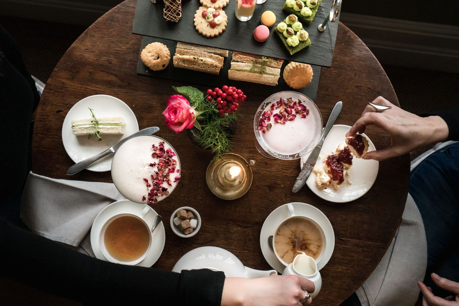 People eat at a elegant table setting.