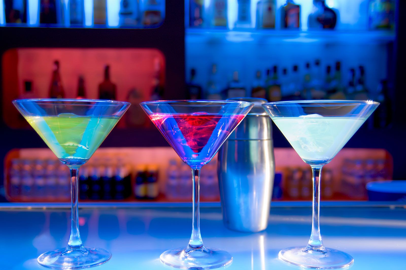 A set of martini glasses with blue background light.