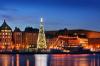 A city skyline view of Stockholm’s Old City with a Christmas tree lit up.