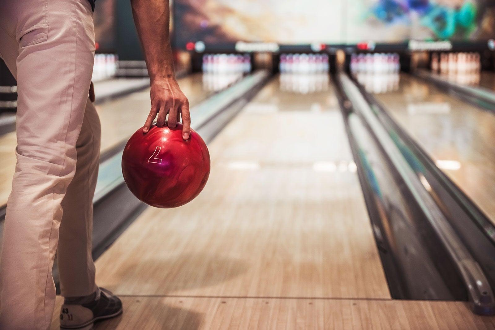 A man gets ready to throw a bowling ball.