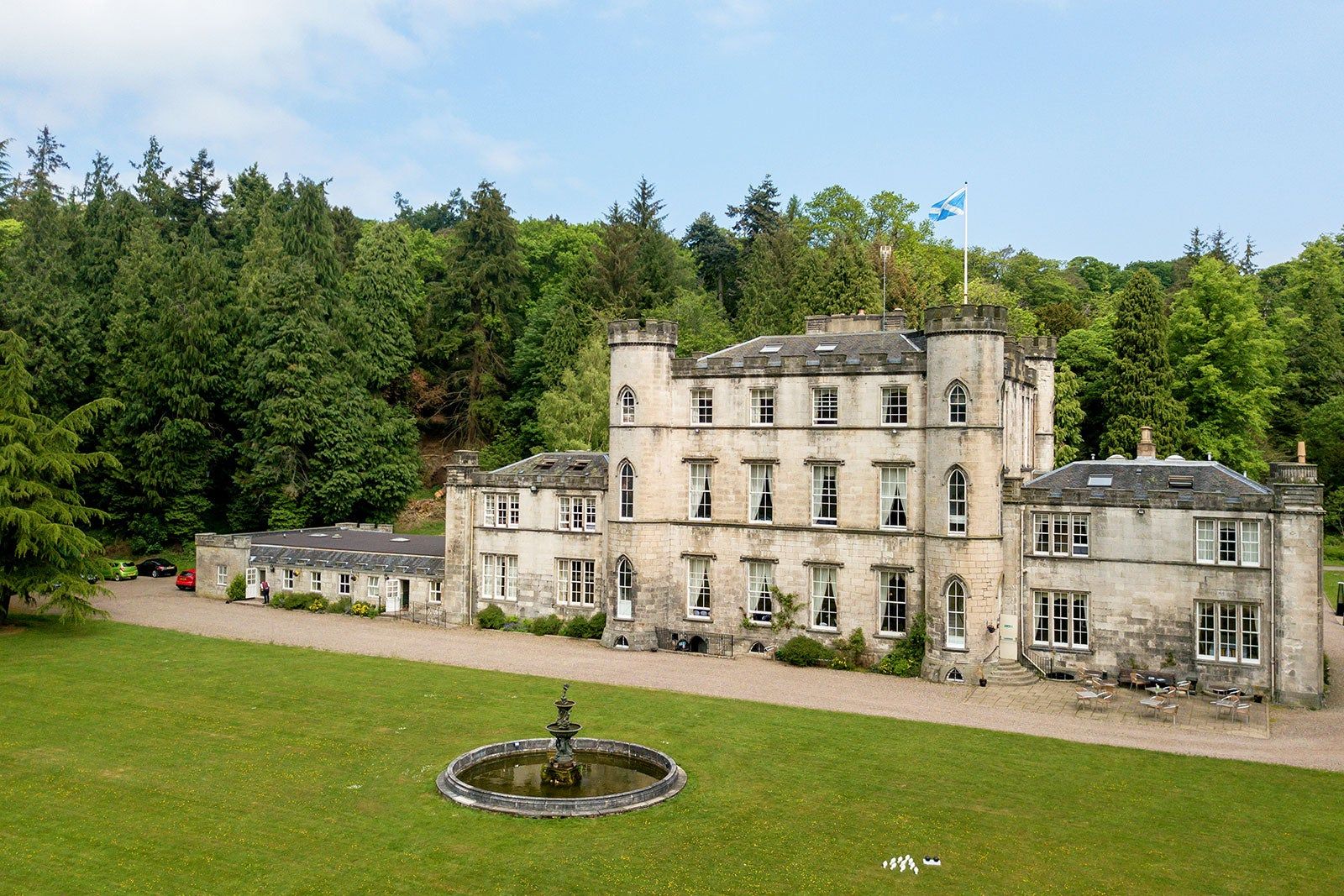 A castle with the Scottish flag flying on the roof.