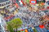 An aerial view of people walking in the crosswalks in Shibuya, Tokyo, Japan.