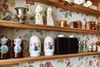 Rows of salt and pepper shakers on a shelf.