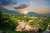 A village in between the trees with sunset view.