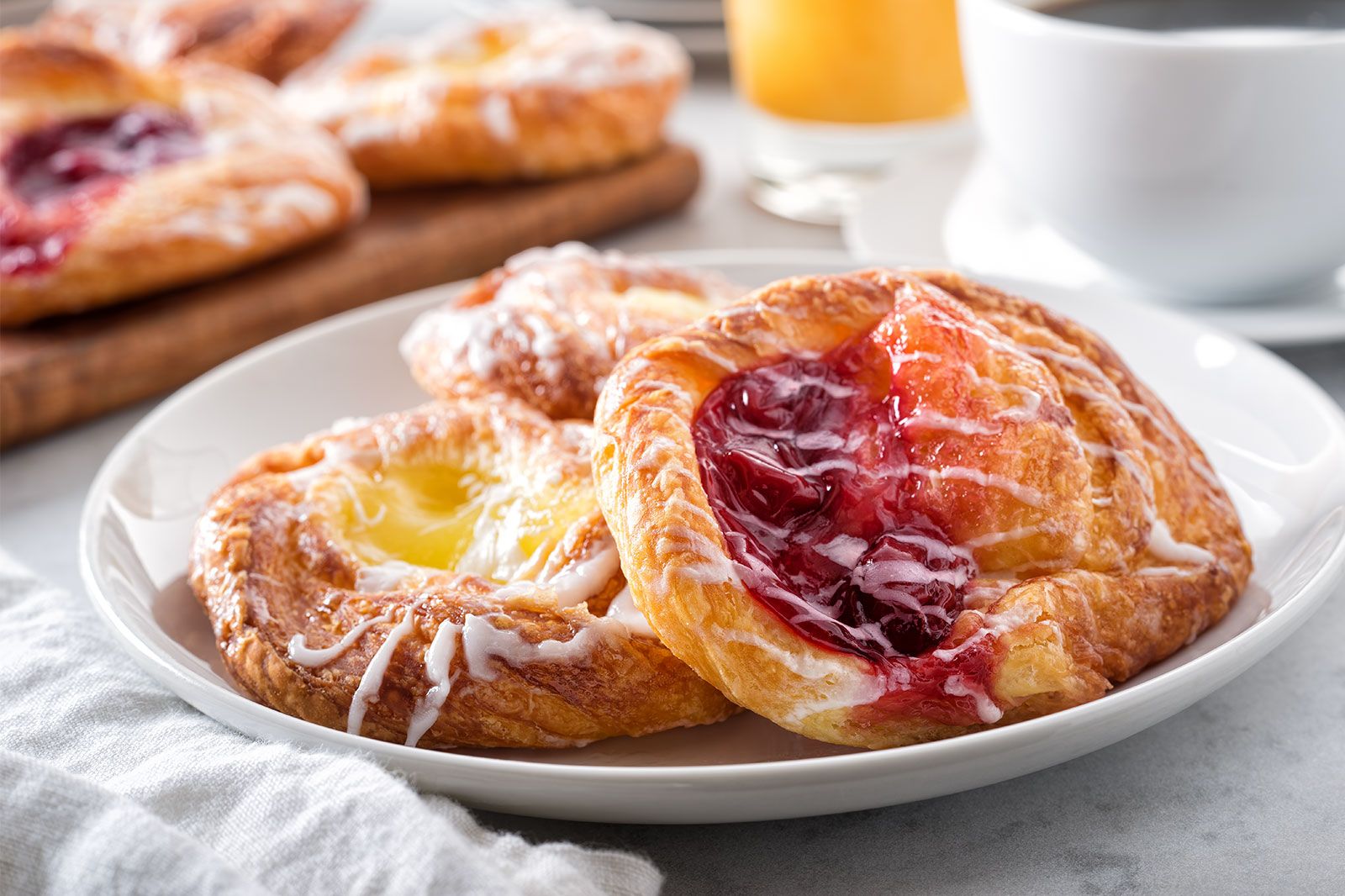 A jelly danish on a white plate.