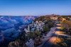 A hotel, perched on a cliffside overlooks the Grand Canyon.